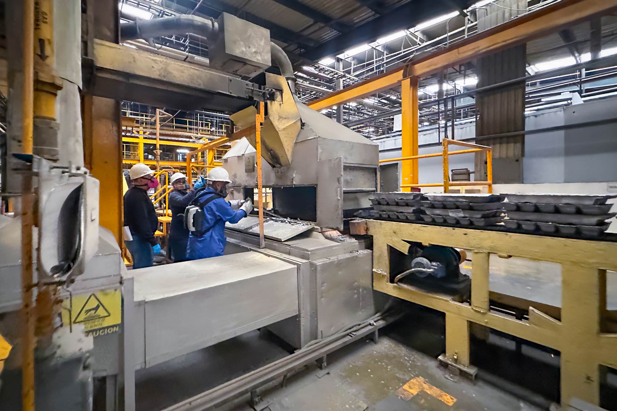 people in factory looking at machinery