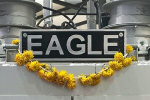 metal EAGLE badge on equipment with flowers