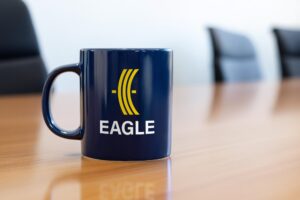 Black coffee mug with new Eagle Manufacturing Systems logo printed on its side