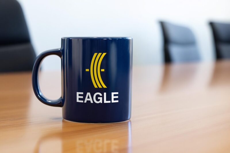 Black coffee mug with new Eagle Manufacturing Systems logo printed on its side