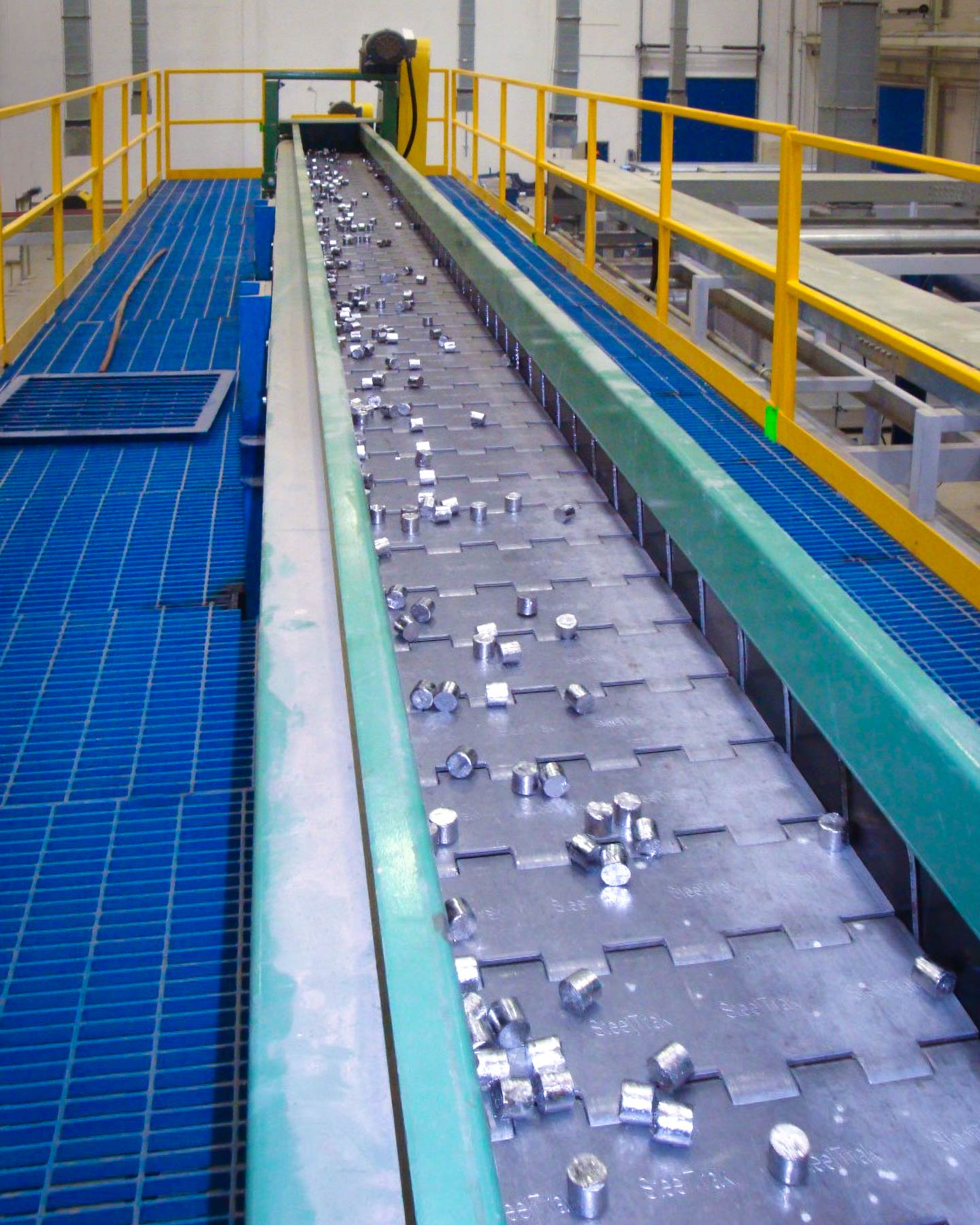 lead pellets on a conveyor in a factory, material handling