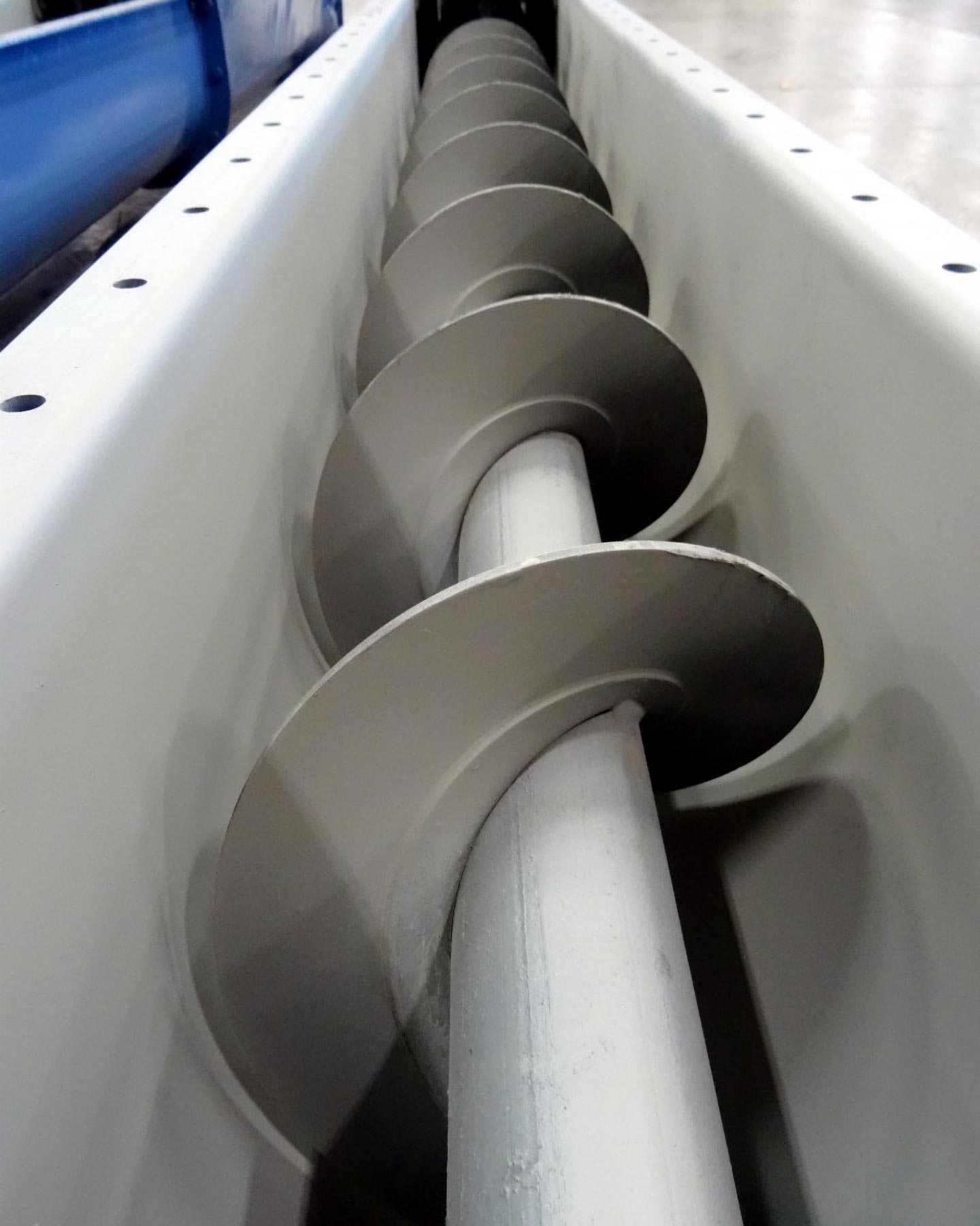 Exposed view of conveyor screws