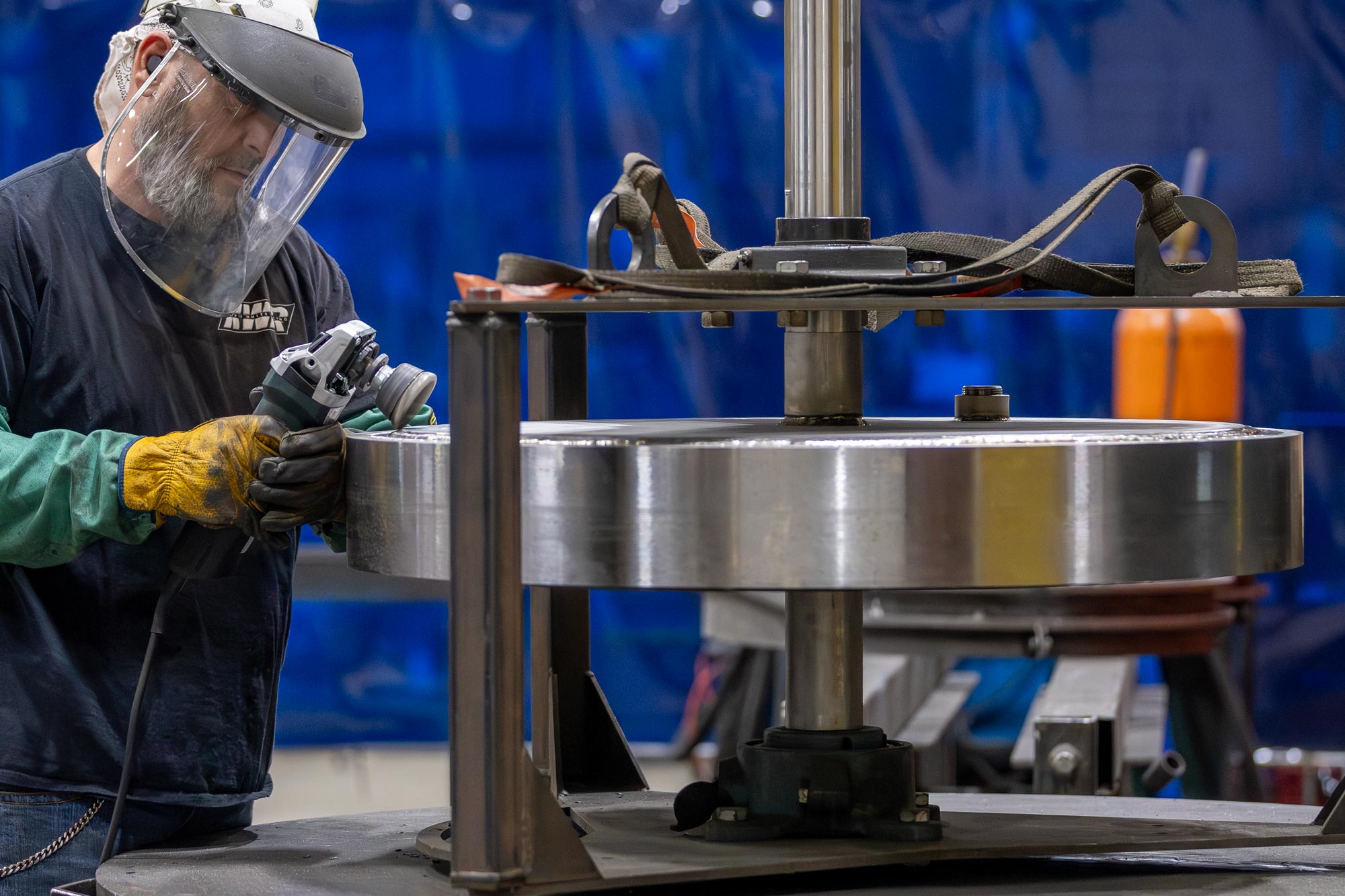 Machinist in factory working on a machine part; workmanship