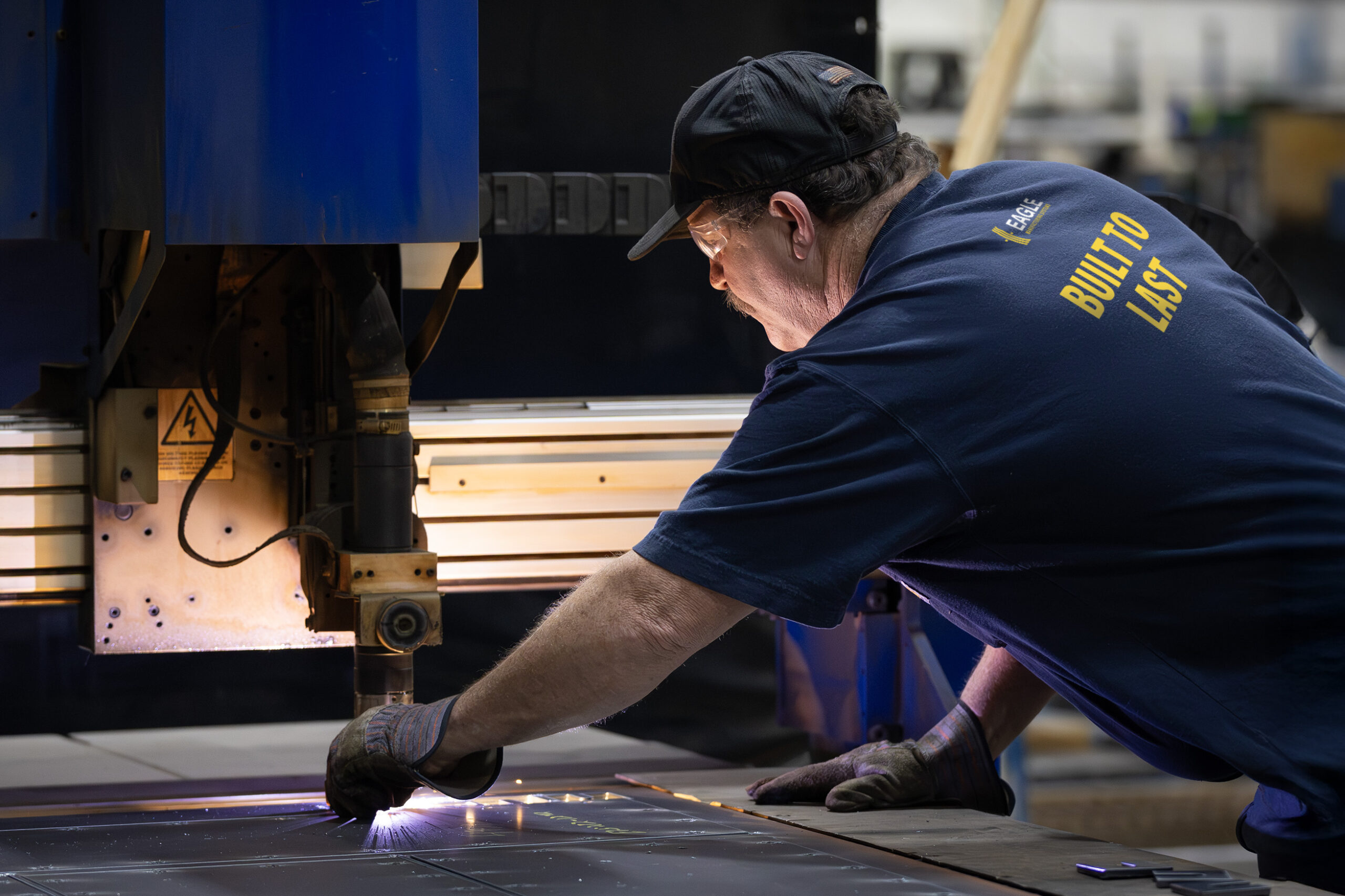 manufacturing worker wearing Eagle brand shirt